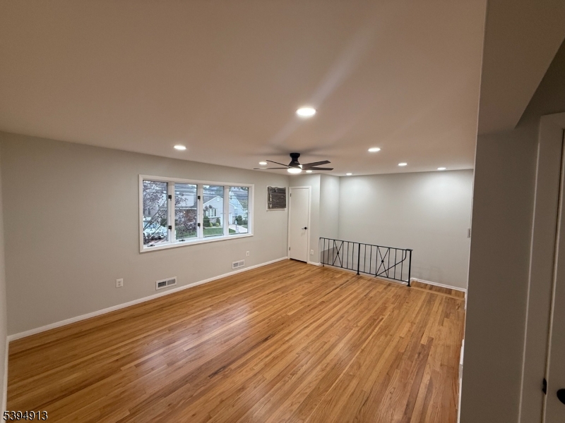 691 9th Street Secaucus, NJ 07094 - Photo 1 of 12 a view of an empty room with window and wooden floor