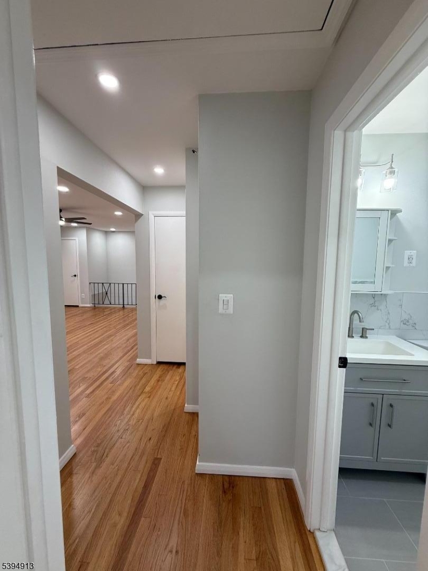 691 9th Street Secaucus, NJ 07094 - Photo 12 of 12 a bathroom with a sink and a mirror