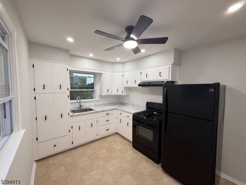 691 9th Street Secaucus, NJ 07094 - Photo 2 of 12 a kitchen with granite countertop a refrigerator and a sink