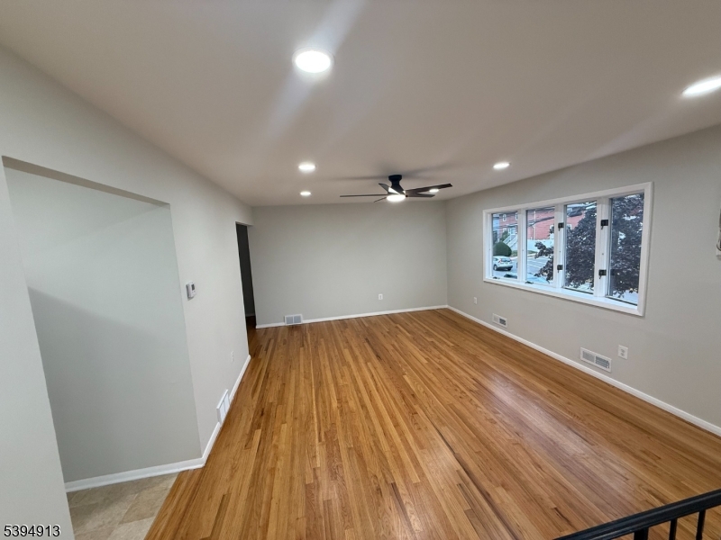 691 9th Street Secaucus, NJ 07094 - Photo 3 of 12 wooden floor in an empty room with a window