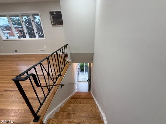 a view of staircase with rug