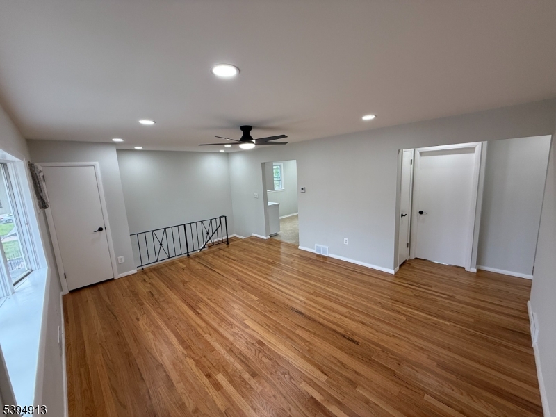 691 9th Street Secaucus, NJ 07094 - Photo 6 of 12 a view of an empty room with wooden floor and a window