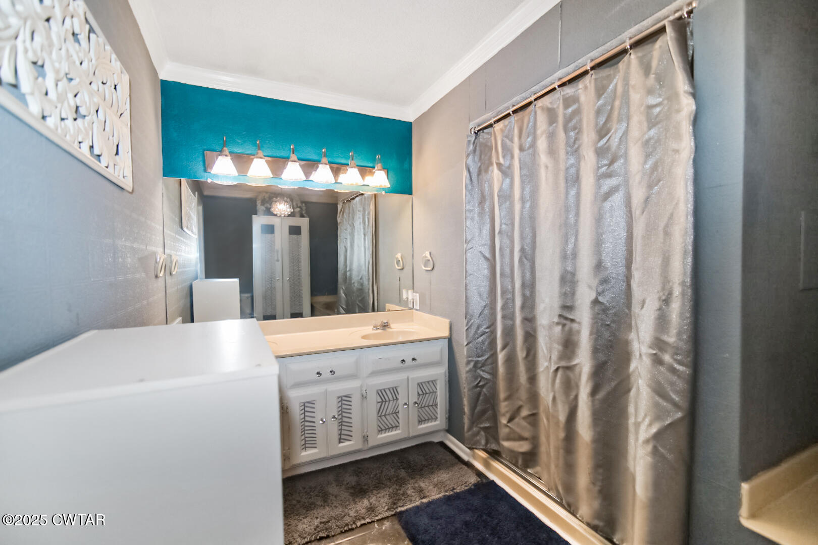 152 Whitfield Drive Jackson, TN 38305 - Photo 12 of 17 a spacious bathroom with a sink a mirror and a shower curtain