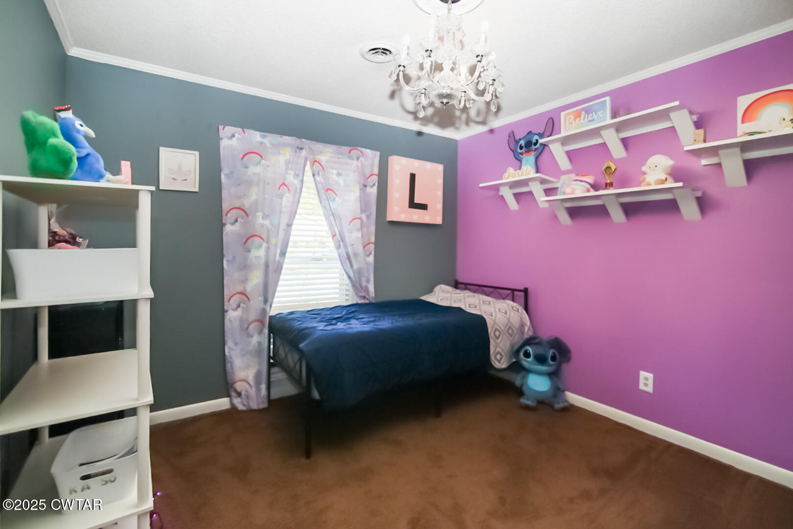 152 Whitfield Drive Jackson, TN 38305 - Photo 14 of 17 a bedroom with a bed and a chandelier