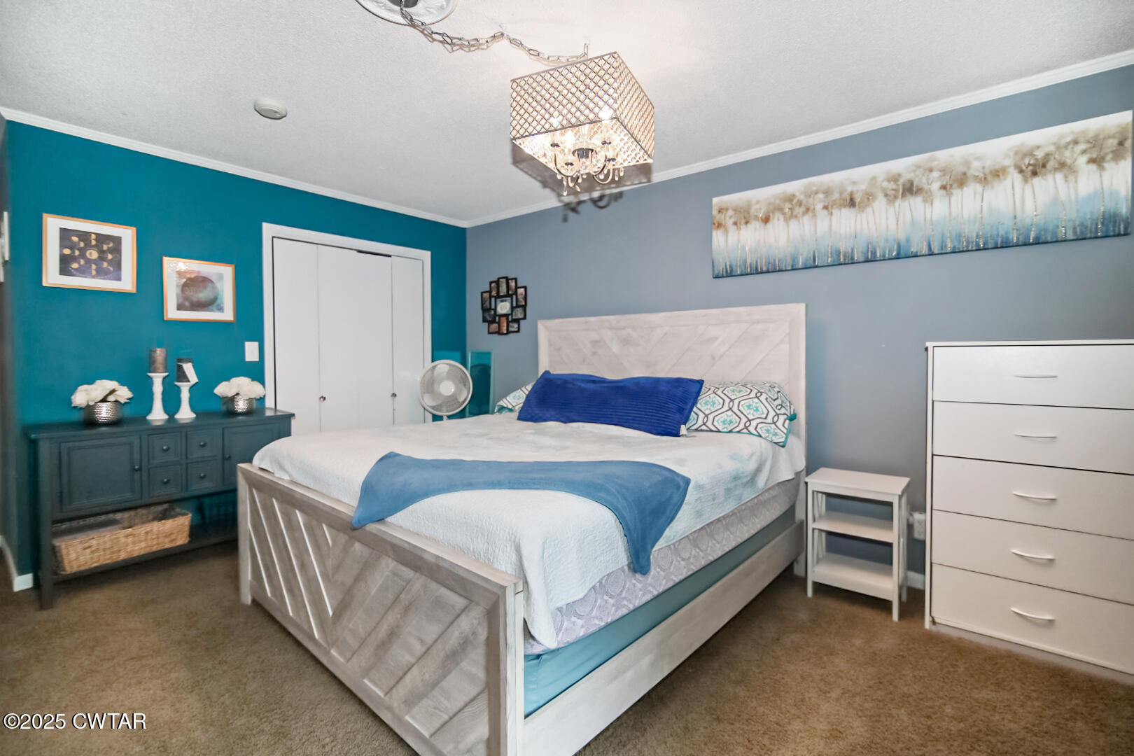 152 Whitfield Drive Jackson, TN 38305 - Photo 3 of 17 a bedroom with a bed and a chandelier