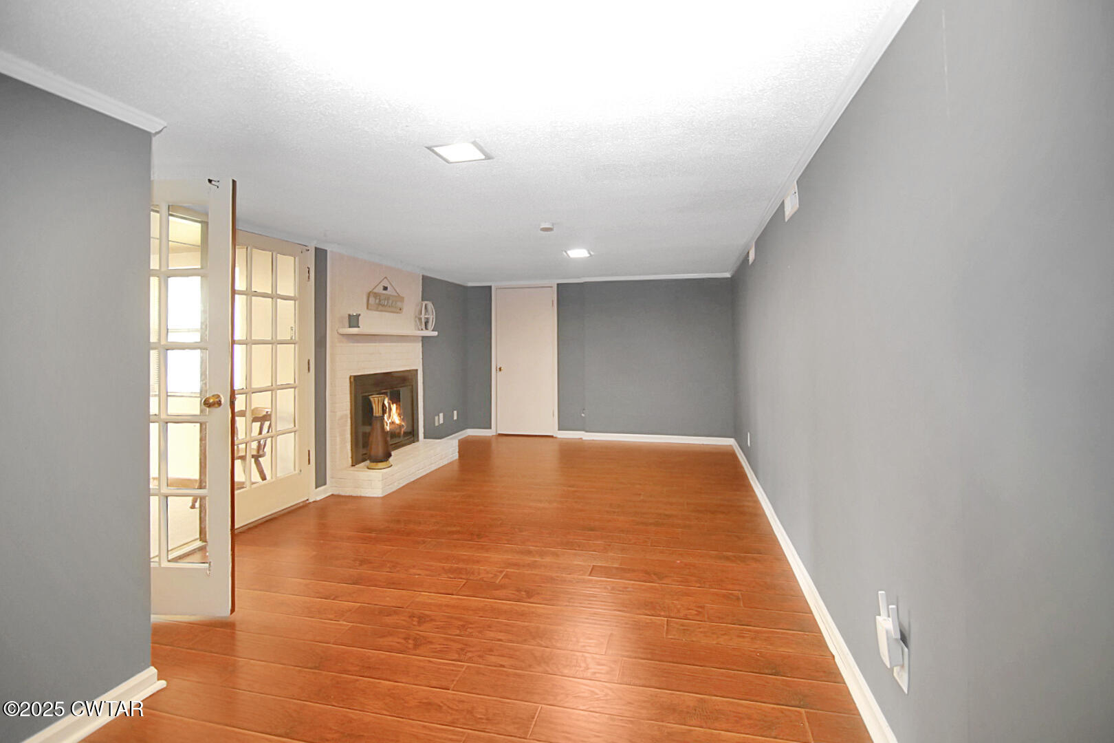 152 Whitfield Drive Jackson, TN 38305 - Photo 7 of 17 a view of empty room with wooden floor and fireplace