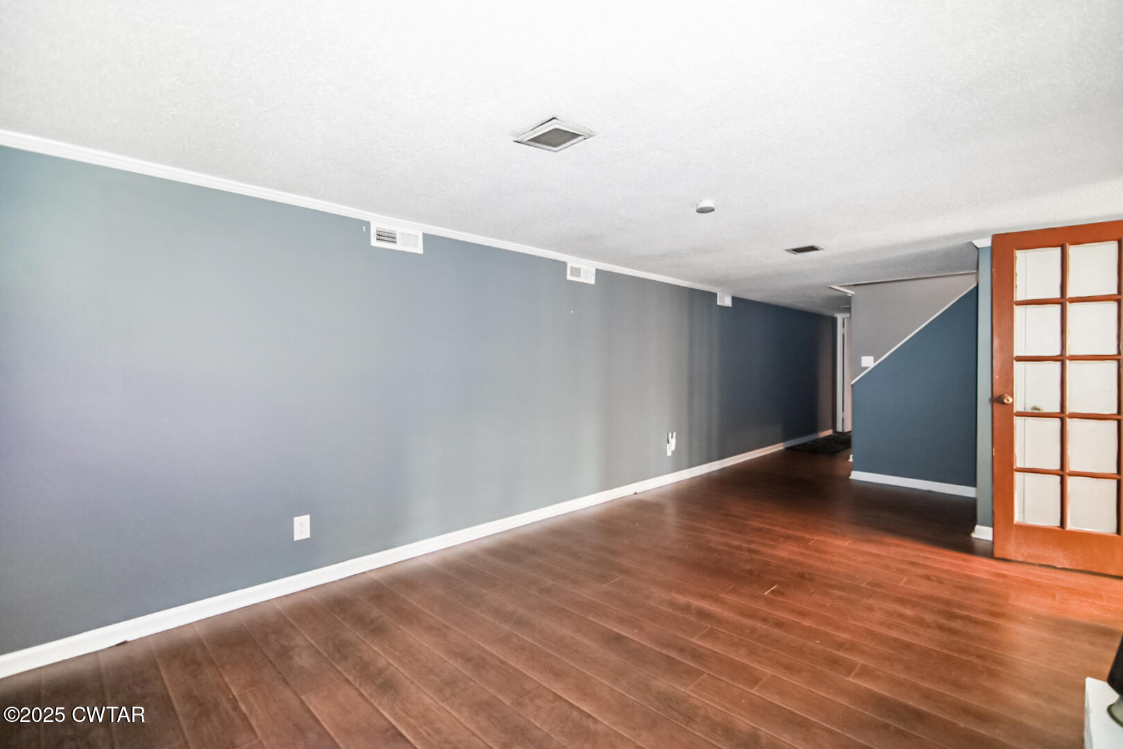 152 Whitfield Drive Jackson, TN 38305 - Photo 8 of 17 a view of an empty room with wooden floor and a window
