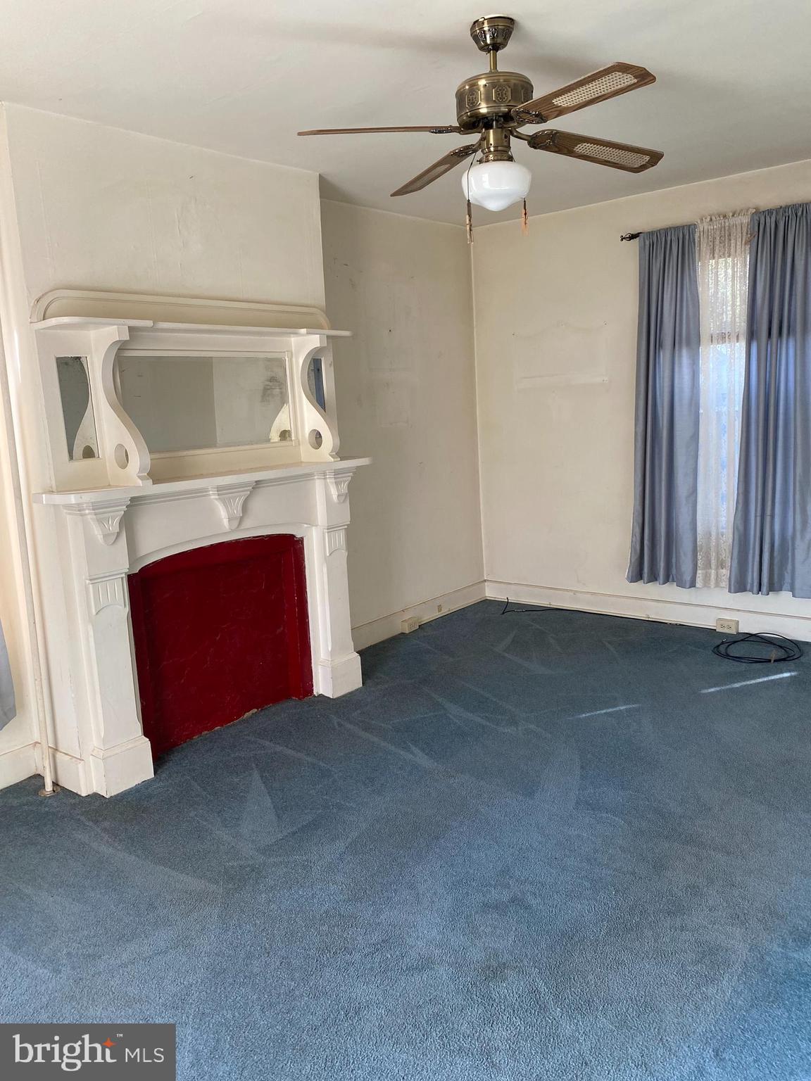 4 Whyte Street Union Bridge, MD 21791 - Photo 20 of 32 a view of an empty room with a fireplace and a ceiling fan