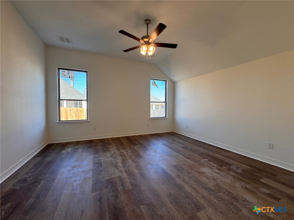 10712 Campsite Cove Temple, TX 76502 - Photo 8 of 11 a view of an empty room with wooden floor and a window