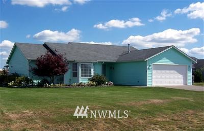9217 Applegate Loop Southwest Rochester, WA 98579 - Photo 1 of 1 a front view of a house with a garden