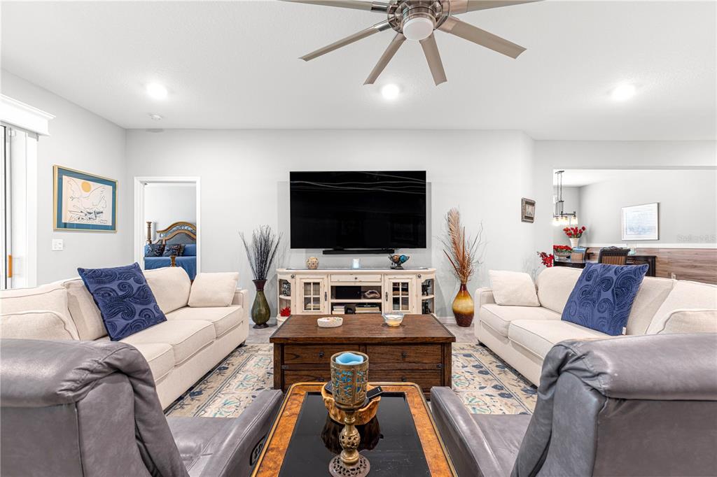 7641 Southwest 63rd Ln Road Ocala, FL 34474 - Photo 15 of 29 a living room with furniture and a flat screen tv