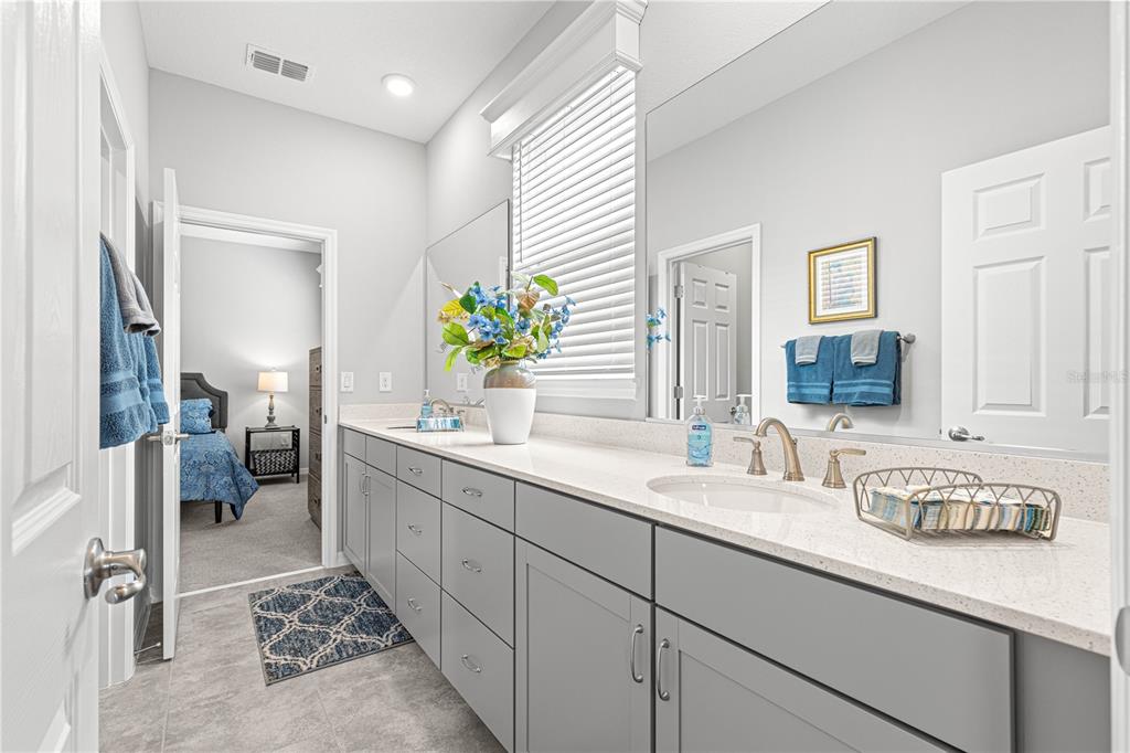 7641 Southwest 63rd Ln Road Ocala, FL 34474 - Photo 5 of 29 a bathroom with a sink double vanity and a mirror