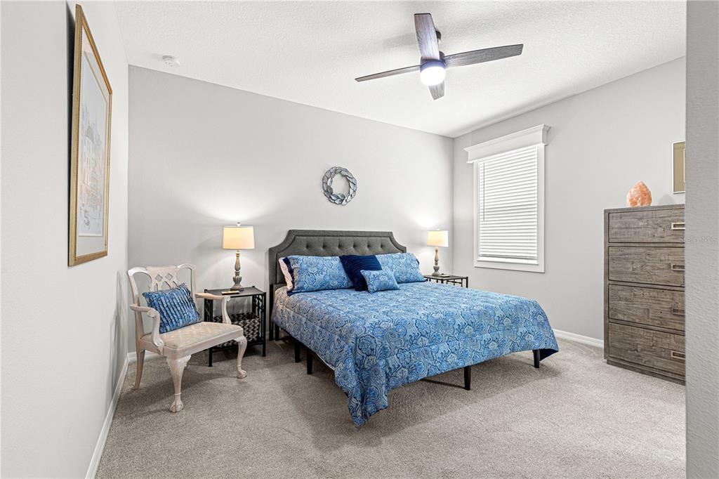 7641 Southwest 63rd Ln Road Ocala, FL 34474 - Photo 7 of 29 a bedroom with a bed and a chandelier