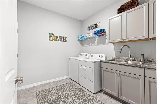a large kitchen with granite countertop lots of counter space and a sink