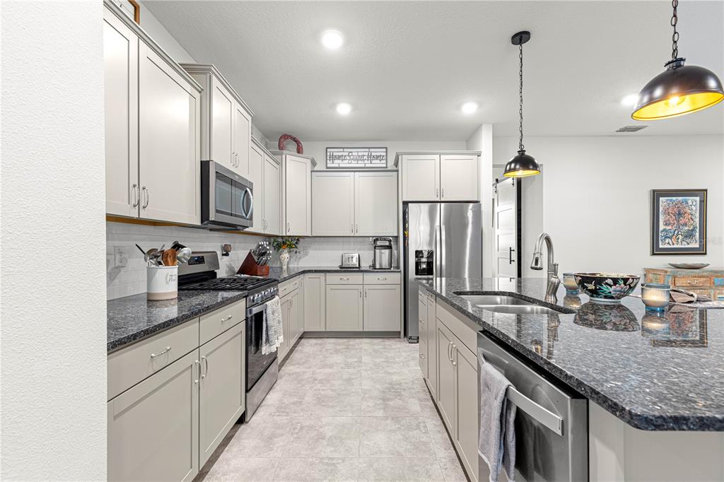 7641 Southwest 63rd Ln Road Ocala, FL 34474 - Photo 10 of 29 a large kitchen with granite countertop lots of counter space and a sink