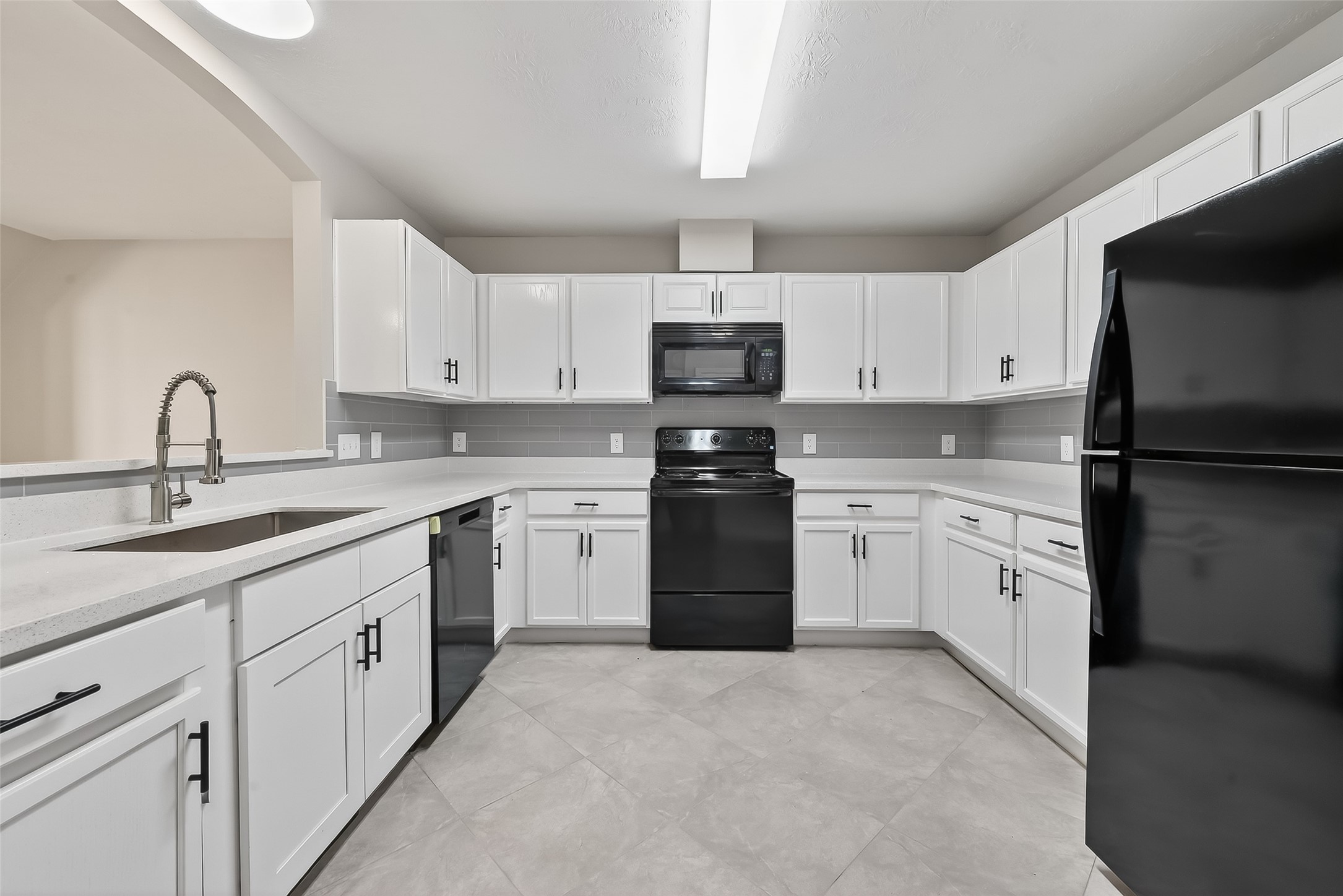 11735 Alief Clodine Road, Unit 36 Houston, TX 77072 - Photo 12 of 27 a kitchen with white cabinets sink and stainless steel appliances