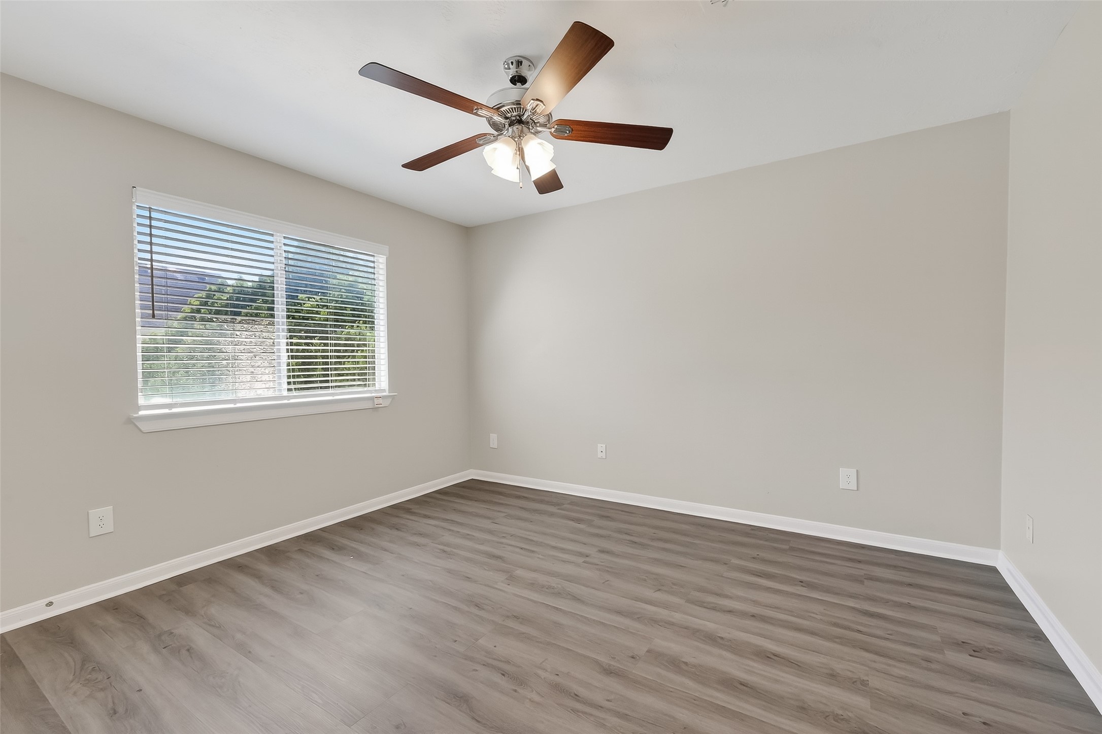11735 Alief Clodine Road, Unit 36 Houston, TX 77072 - Photo 17 of 27 wooden floor in an empty room with a window