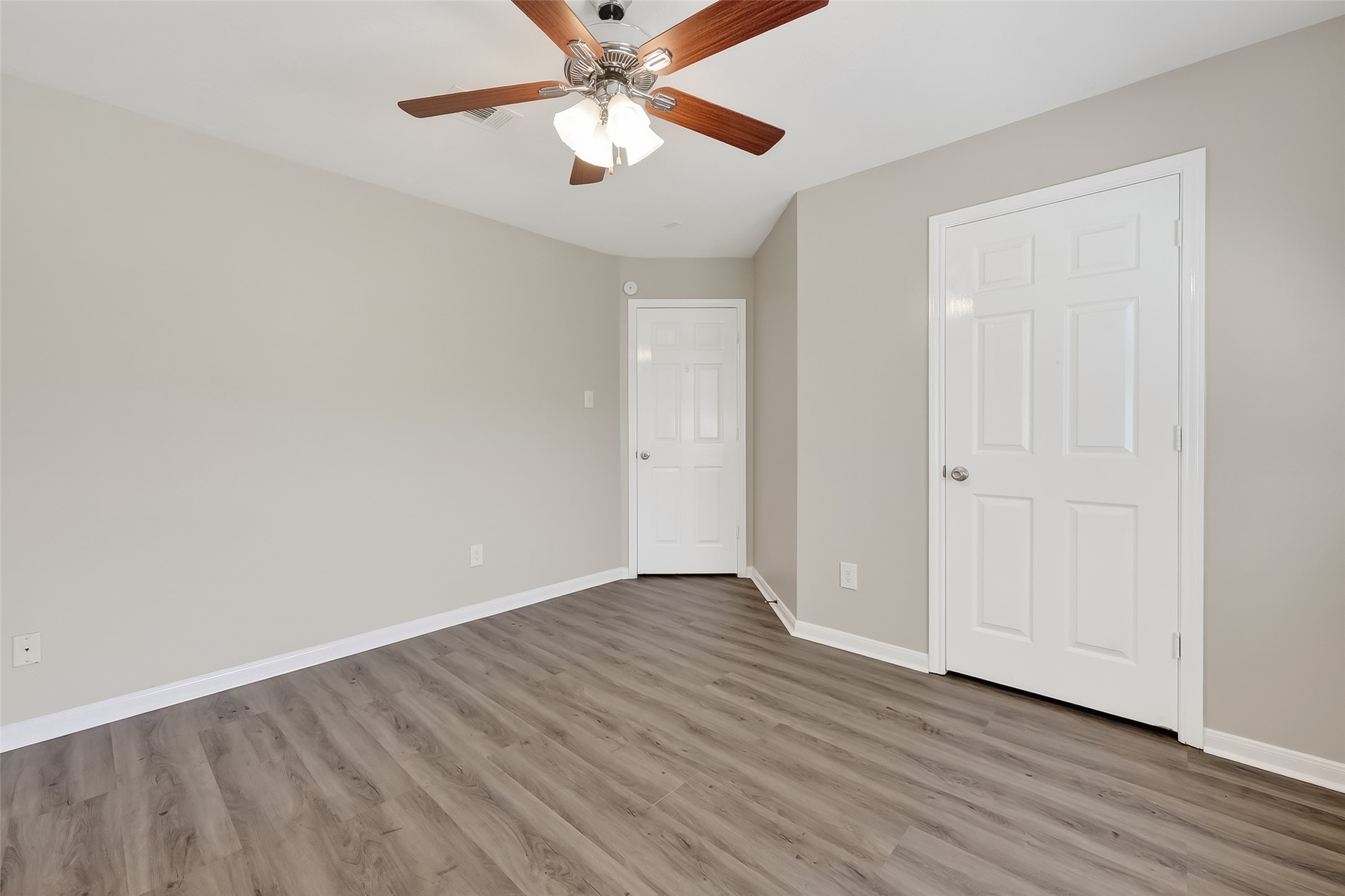 11735 Alief Clodine Road, Unit 36 Houston, TX 77072 - Photo 18 of 27 an empty room with wooden floor chandelier fan and closet area