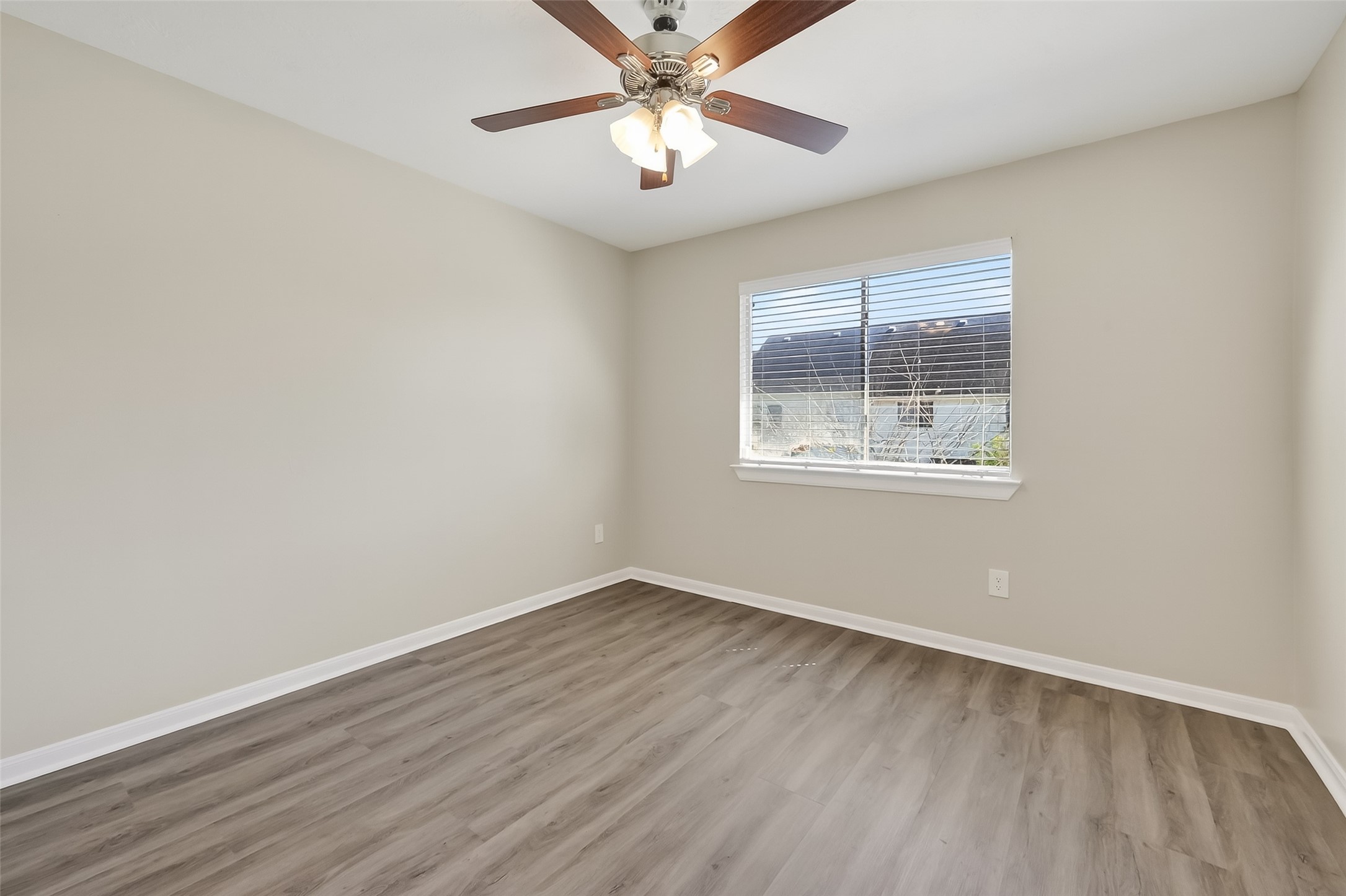 11735 Alief Clodine Road, Unit 36 Houston, TX 77072 - Photo 19 of 27 an empty room with wooden floor and windows