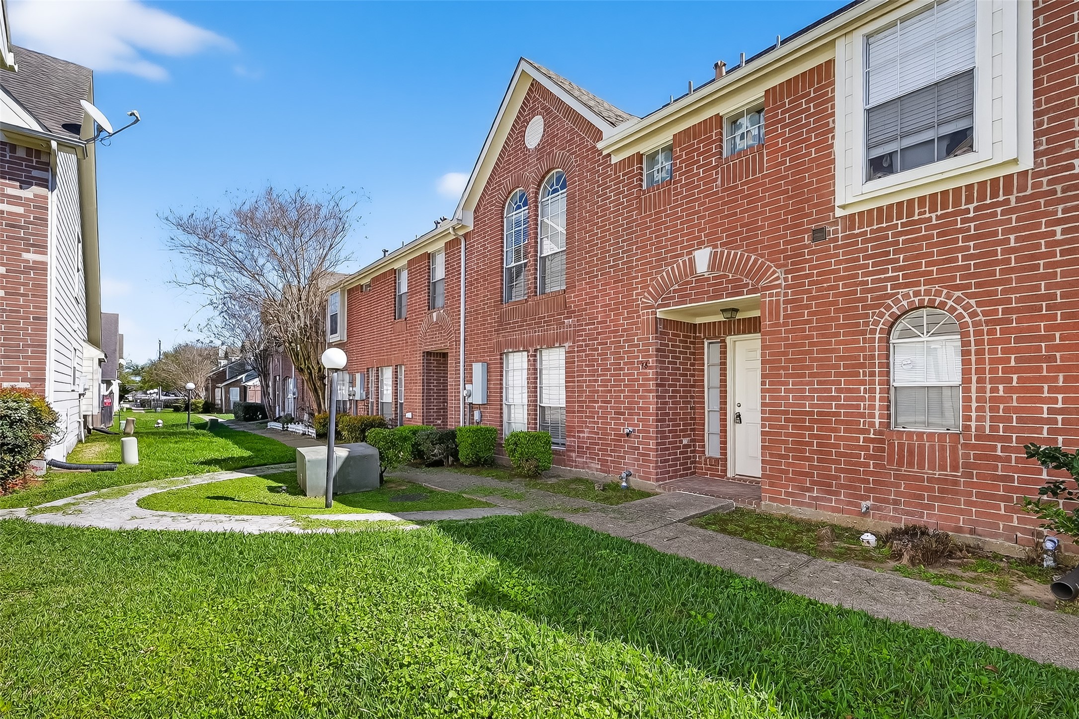 11735 Alief Clodine Road, Unit 36 Houston, TX 77072 - Photo 2 of 27 a front view of a house with garden and trees