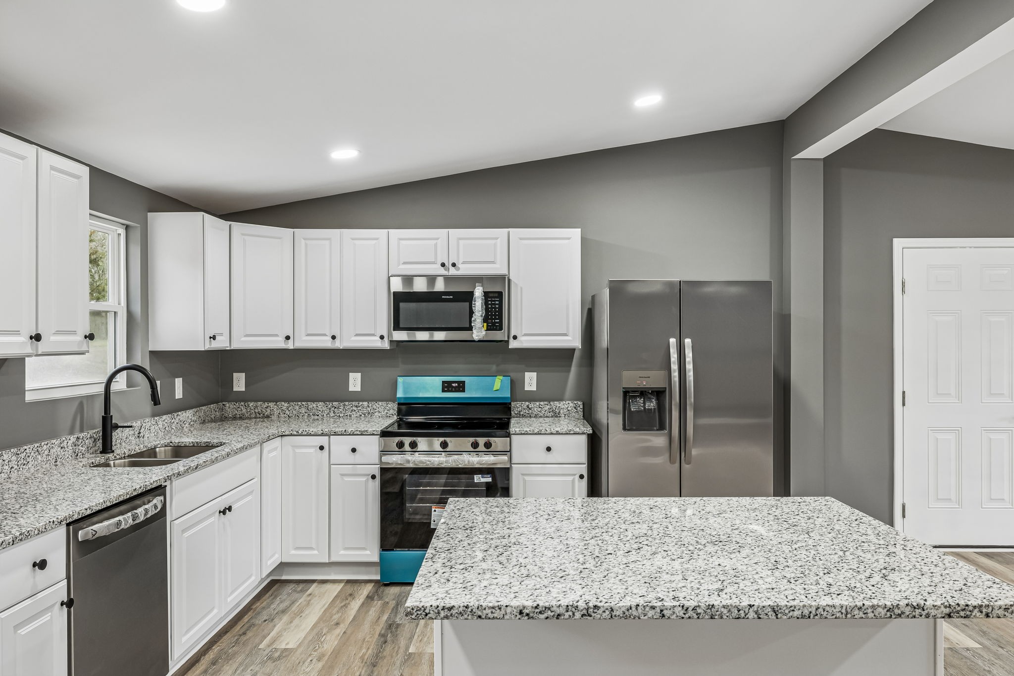 1985 Mosley Ferry Road Chapmansboro, TN 37035 - Photo 12 of 24 a kitchen with stainless steel appliances granite countertop a sink a stove a refrigerator and cabinets