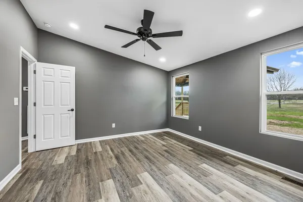 a view of room with window and ceiling fan