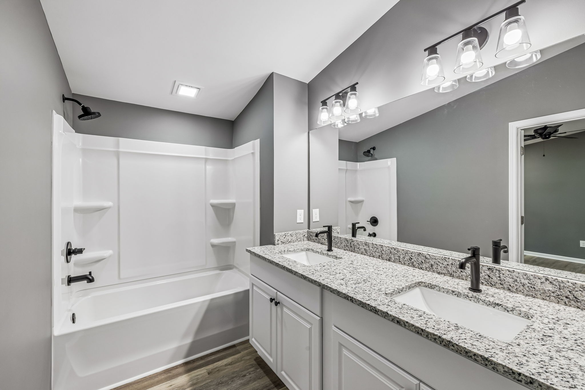 1985 Mosley Ferry Road Chapmansboro, TN 37035 - Photo 15 of 24 a bathroom with a granite countertop bathtub a sink and a mirror