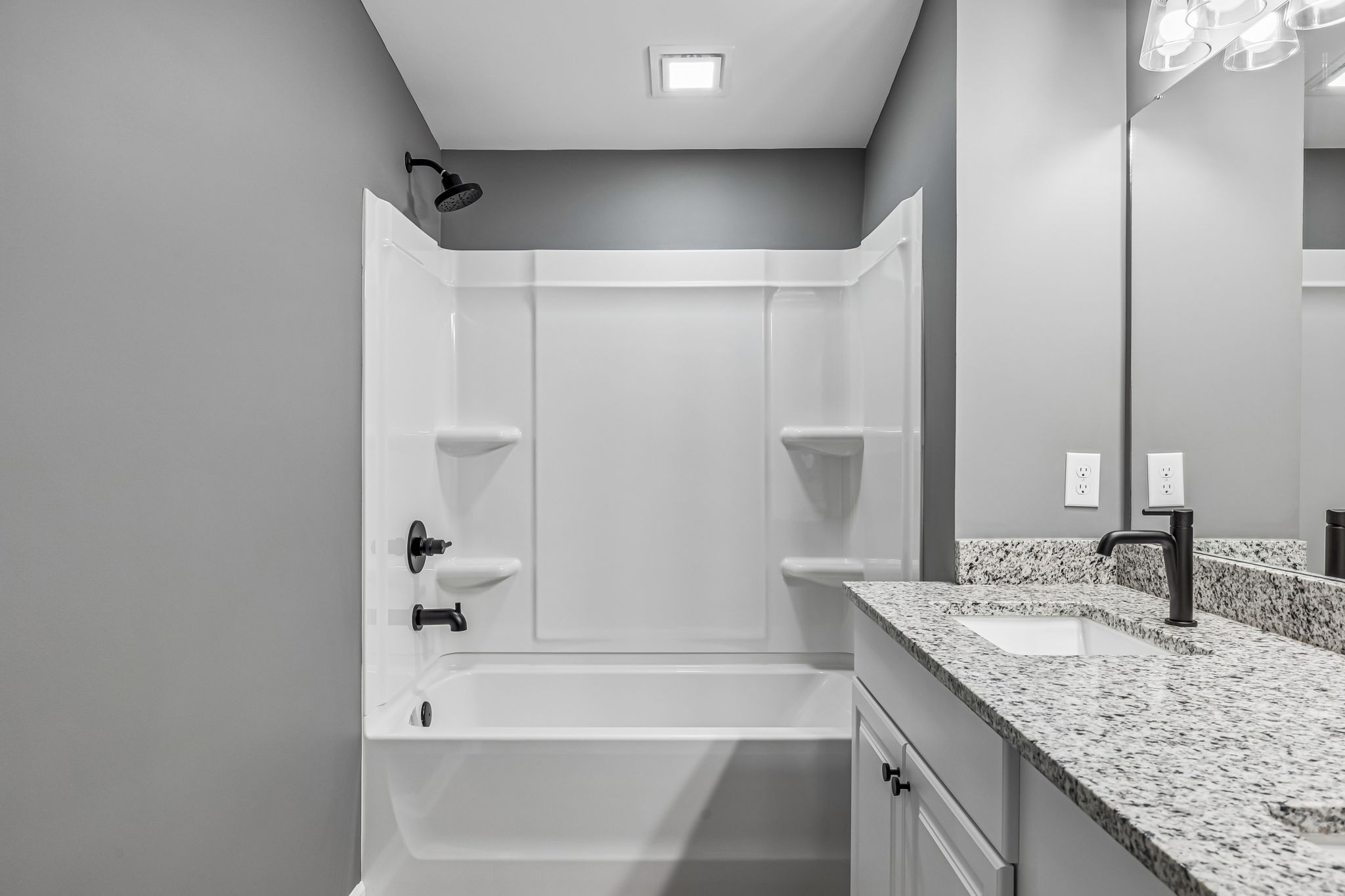 1985 Mosley Ferry Road Chapmansboro, TN 37035 - Photo 16 of 24 a bathroom with a granite countertop sink and a mirror a bathtub