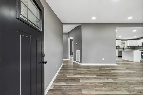 a view of a hallway with a kitchen