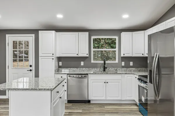 a kitchen with a sink a window and stainless steel appliances