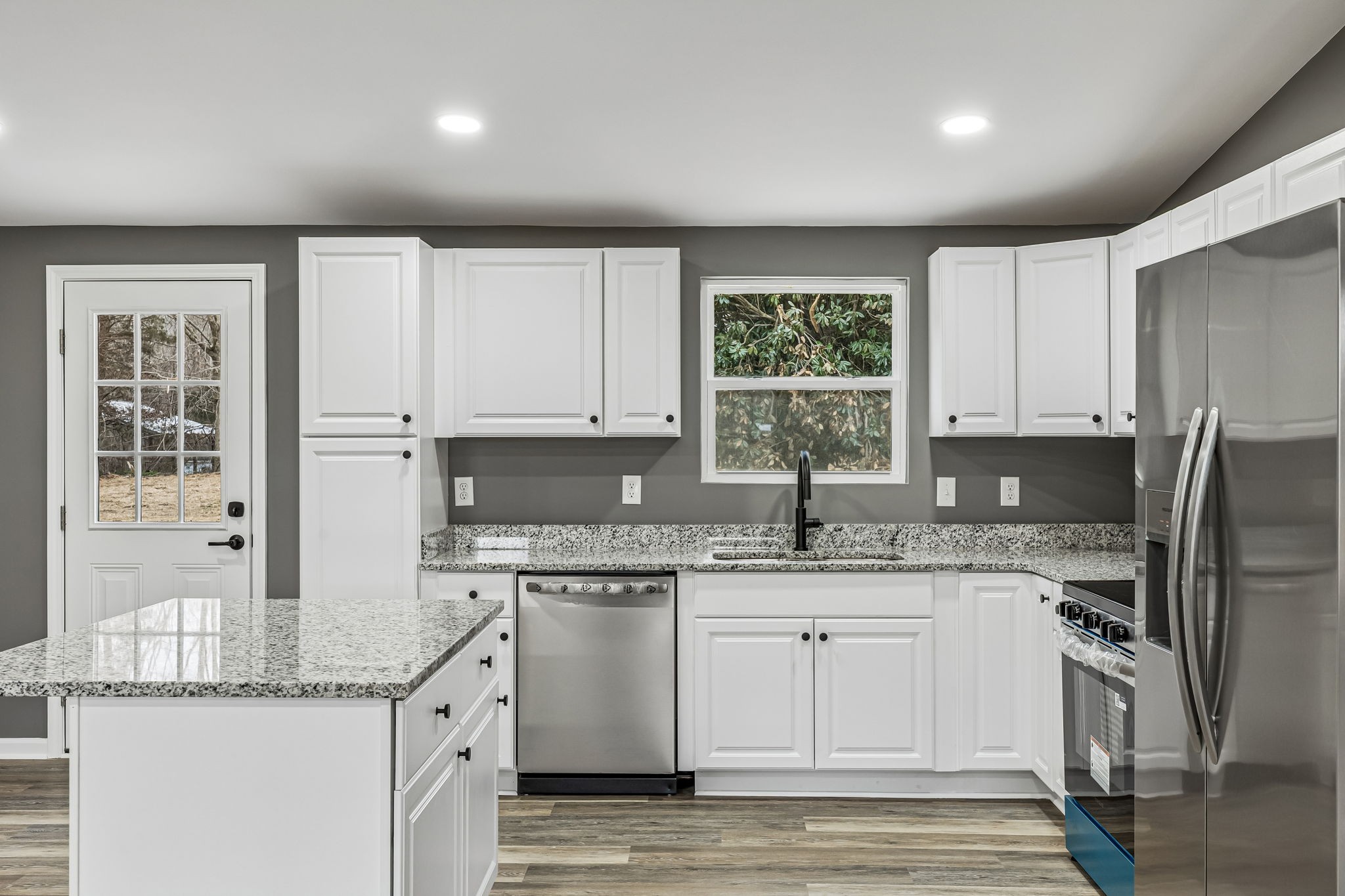 1985 Mosley Ferry Road Chapmansboro, TN 37035 - Photo 8 of 24 a kitchen with a sink a window and stainless steel appliances