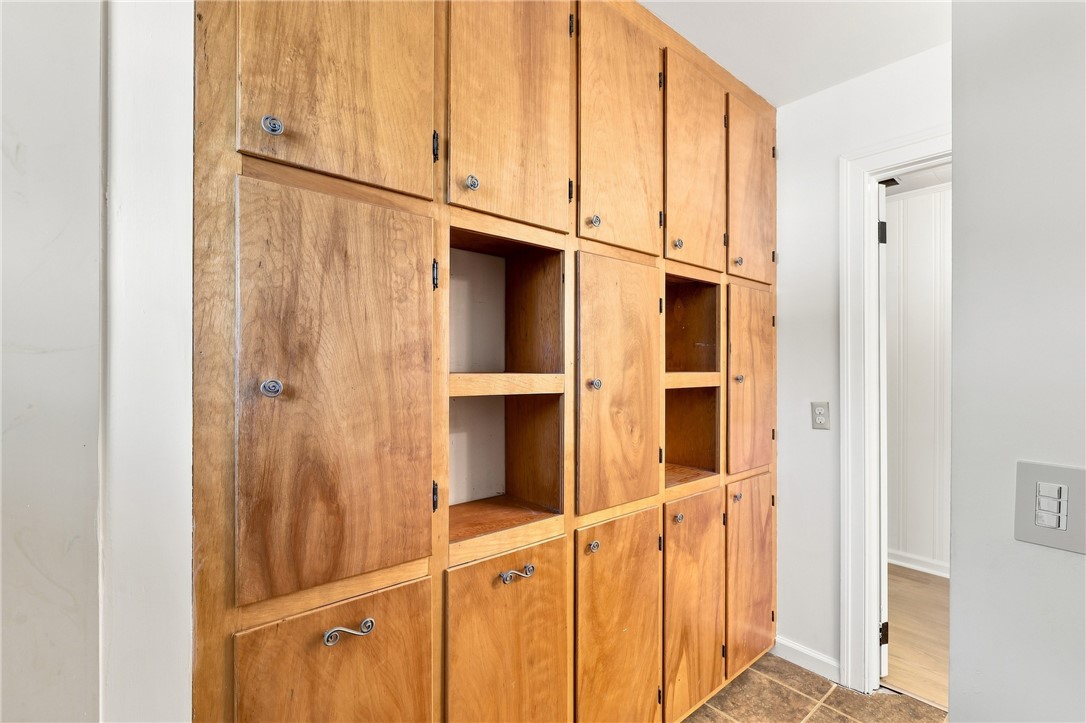 205 Timms Road Piedmont, SC 29673 - Photo 17 of 36 Extensive built-in wood cabinetry provides abundant storage solutions alongside a tiled floor.