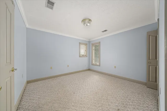 a large room with wooden floor and furniture