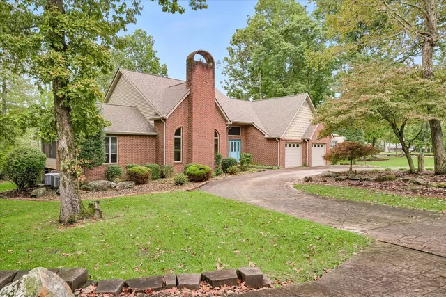 a front view of a house with a yard and porch