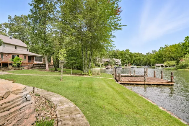 a view of a house with a backyard and a patio