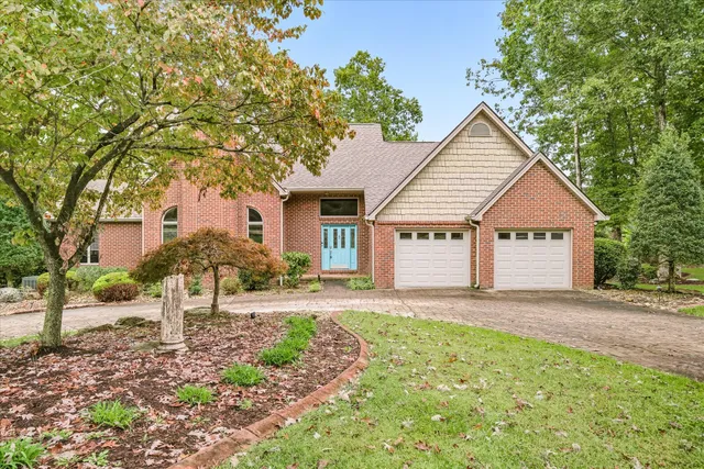 a view of backyard of house with green space