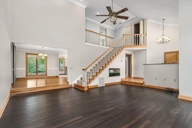 a view of a livingroom with wooden floor fireplace and a window