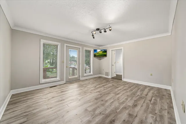 a bathroom with a sink shower and a mirror