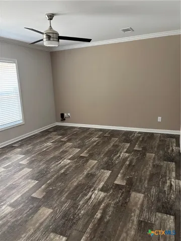 a view of a room with an empty space and a window