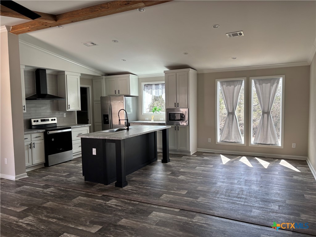 320 Fawn Drive Spring Branch, TX 78070 - Photo 4 of 16 a large kitchen with kitchen island granite countertop a stove top oven a sink dishwasher a dining table and chairs with wooden floor