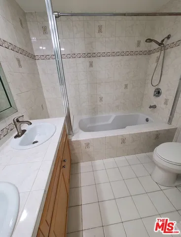 a bathroom with a sink a toilet and a bathtub