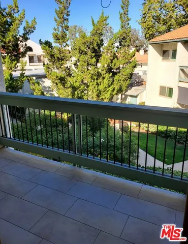 a view of balcony with wooden floor