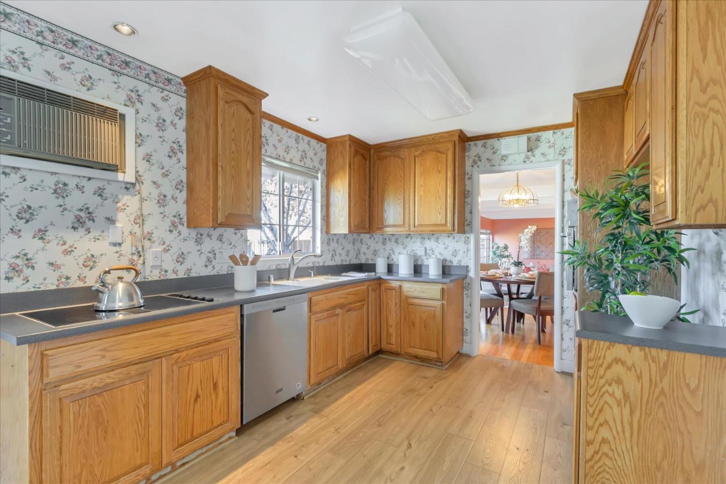 727 Valley Way Santa Clara, CA 95051 - Photo 11 of 52 a kitchen with a sink a microwave cabinets and wooden floor