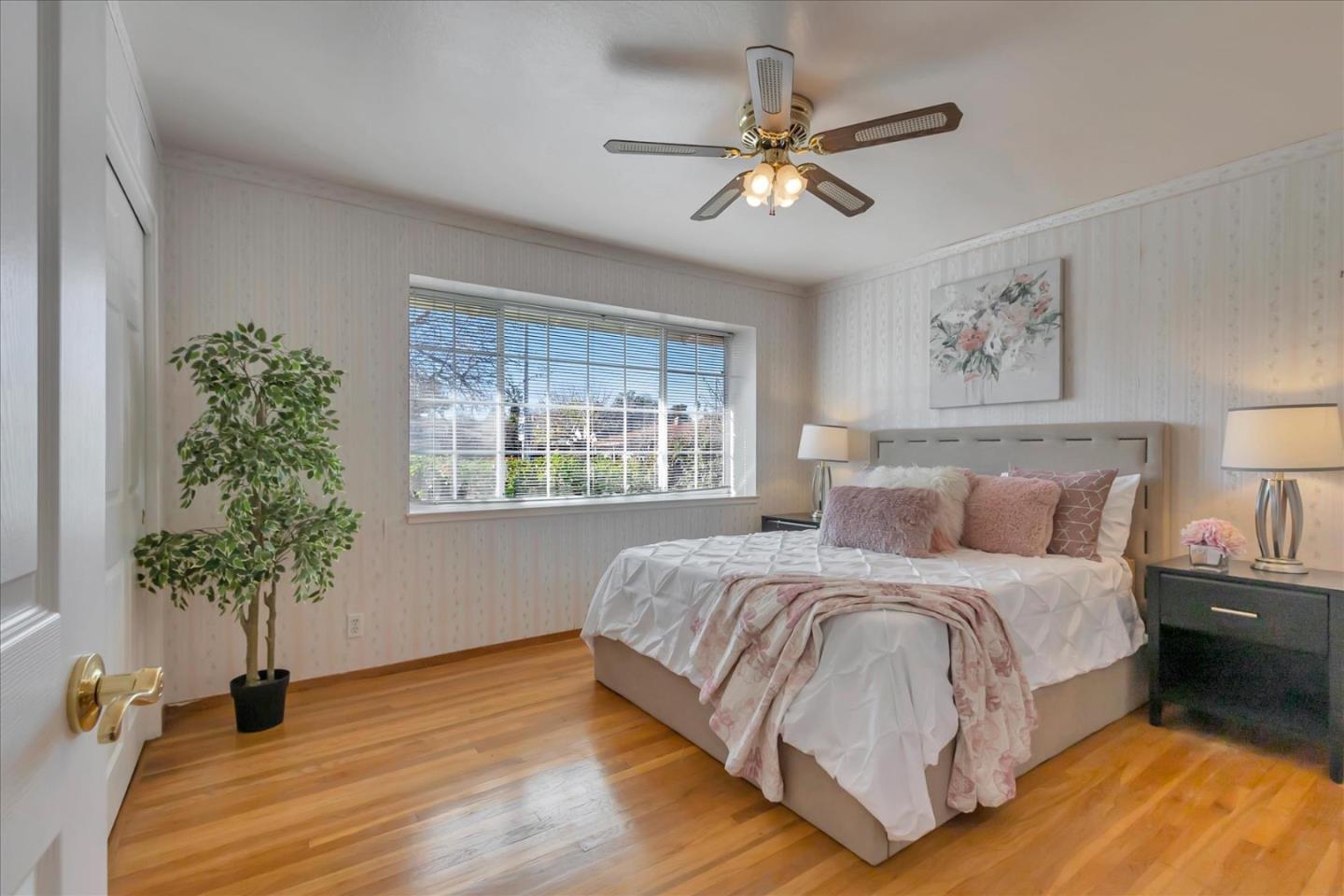 727 Valley Way Santa Clara, CA 95051 - Photo 19 of 52 a bedroom with a large bed and a potted plant