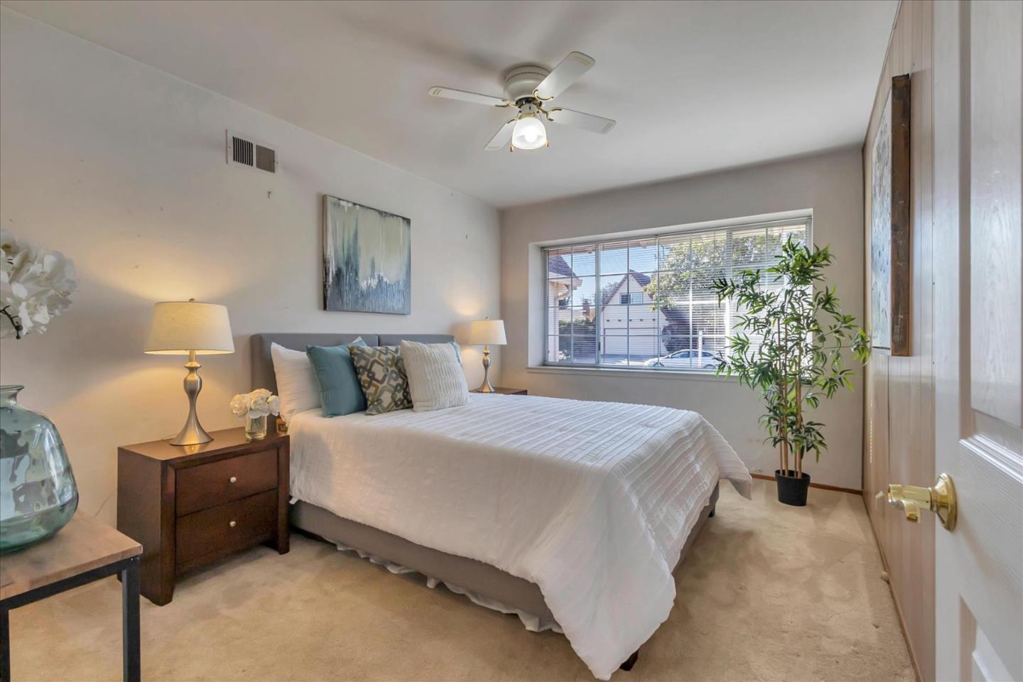 727 Valley Way Santa Clara, CA 95051 - Photo 29 of 52 a spacious bedroom with a bed a window and potted plant