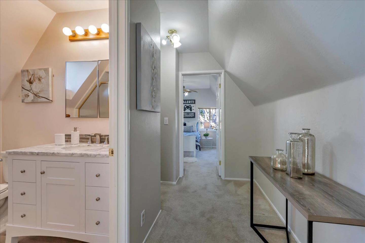 727 Valley Way Santa Clara, CA 95051 - Photo 38 of 52 a bathroom with a sink a light fixture a mirror and a shower