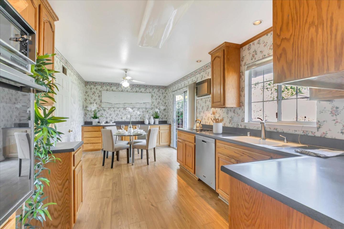 727 Valley Way Santa Clara, CA 95051 - Photo 9 of 52 a dining room with furniture a large window and wooden floor