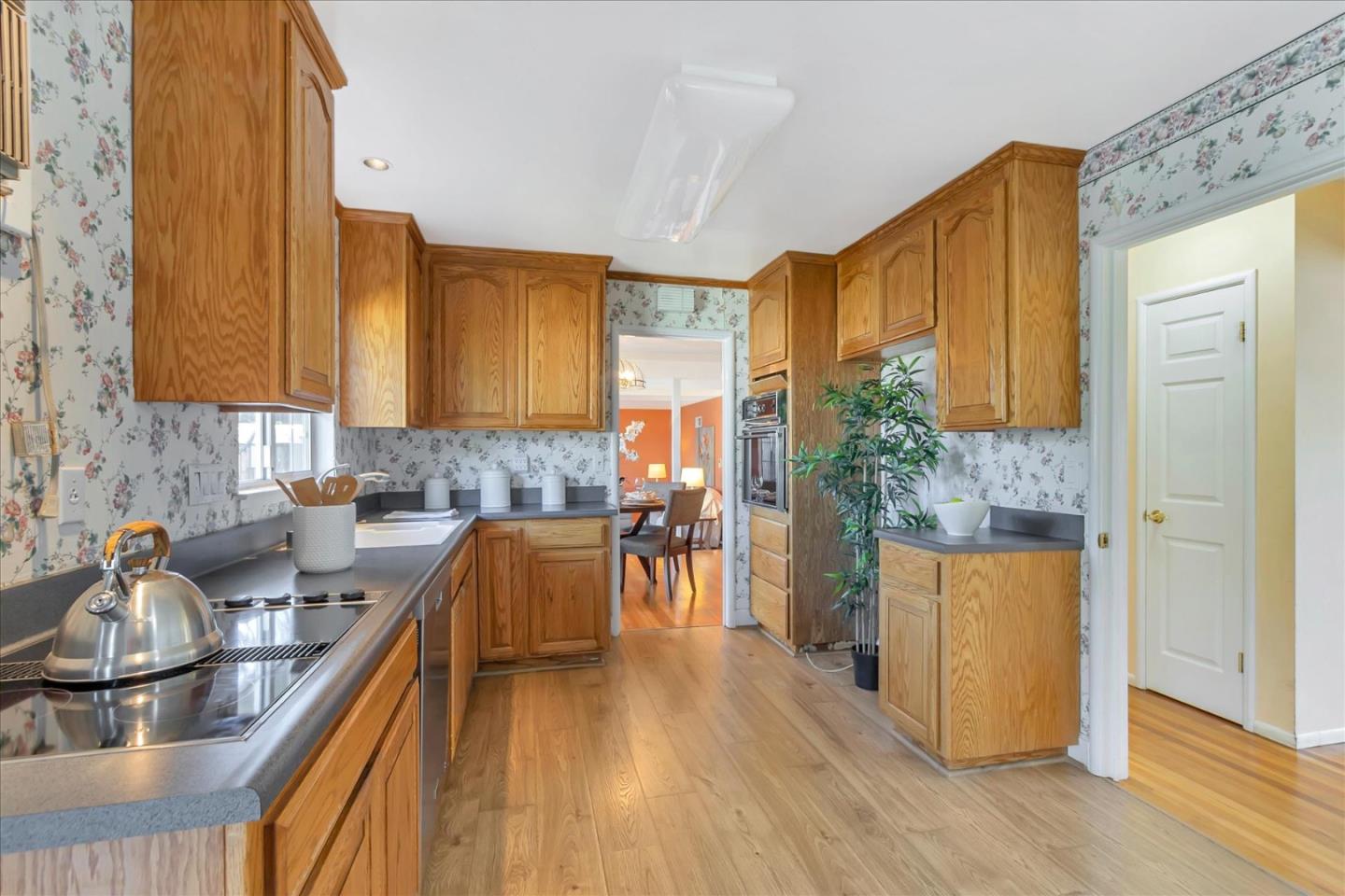 727 Valley Way Santa Clara, CA 95051 - Photo 10 of 52 a kitchen with a sink a refrigerator and wooden cabinets