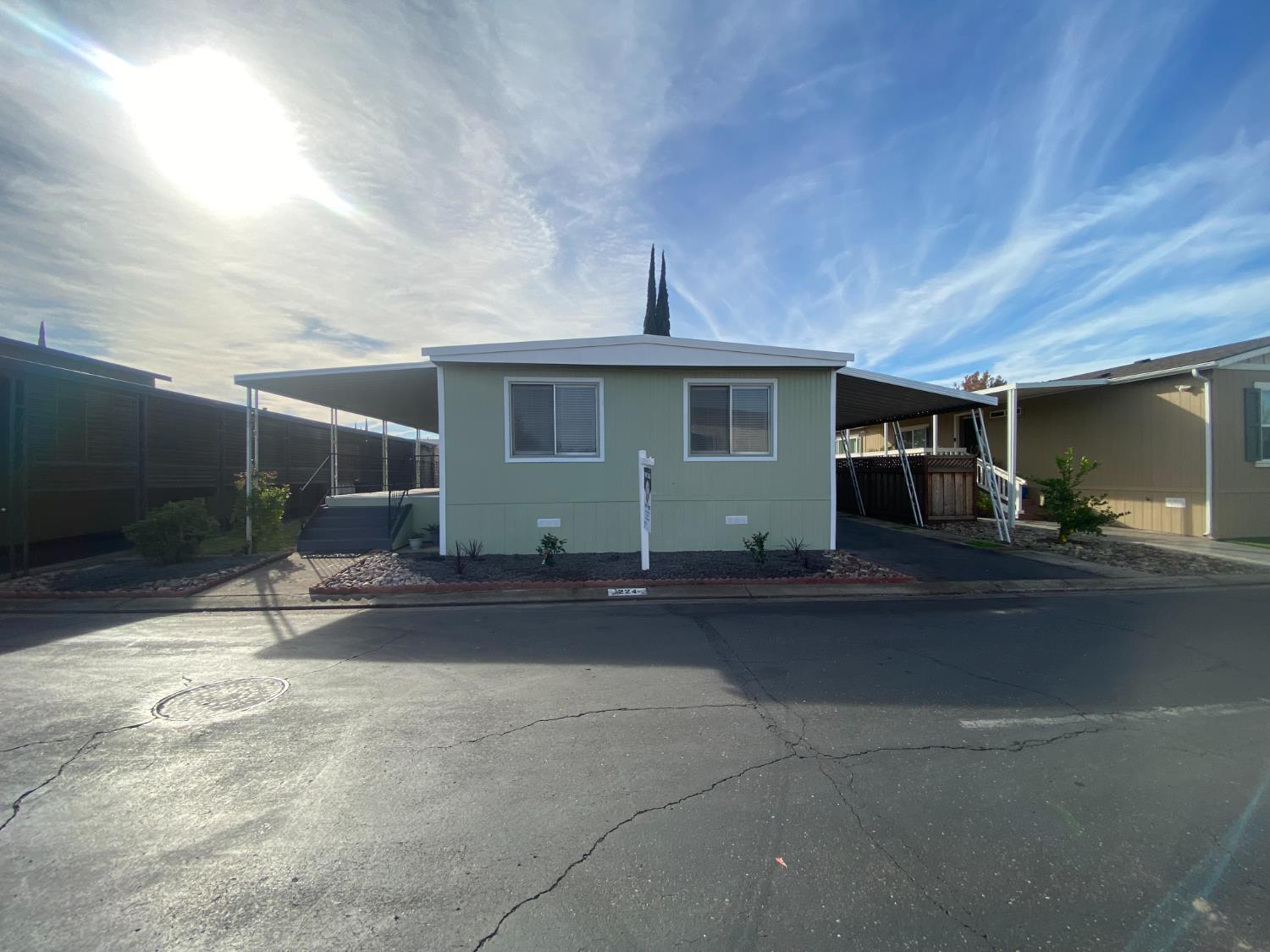 a view of a house with backyard and sitting area