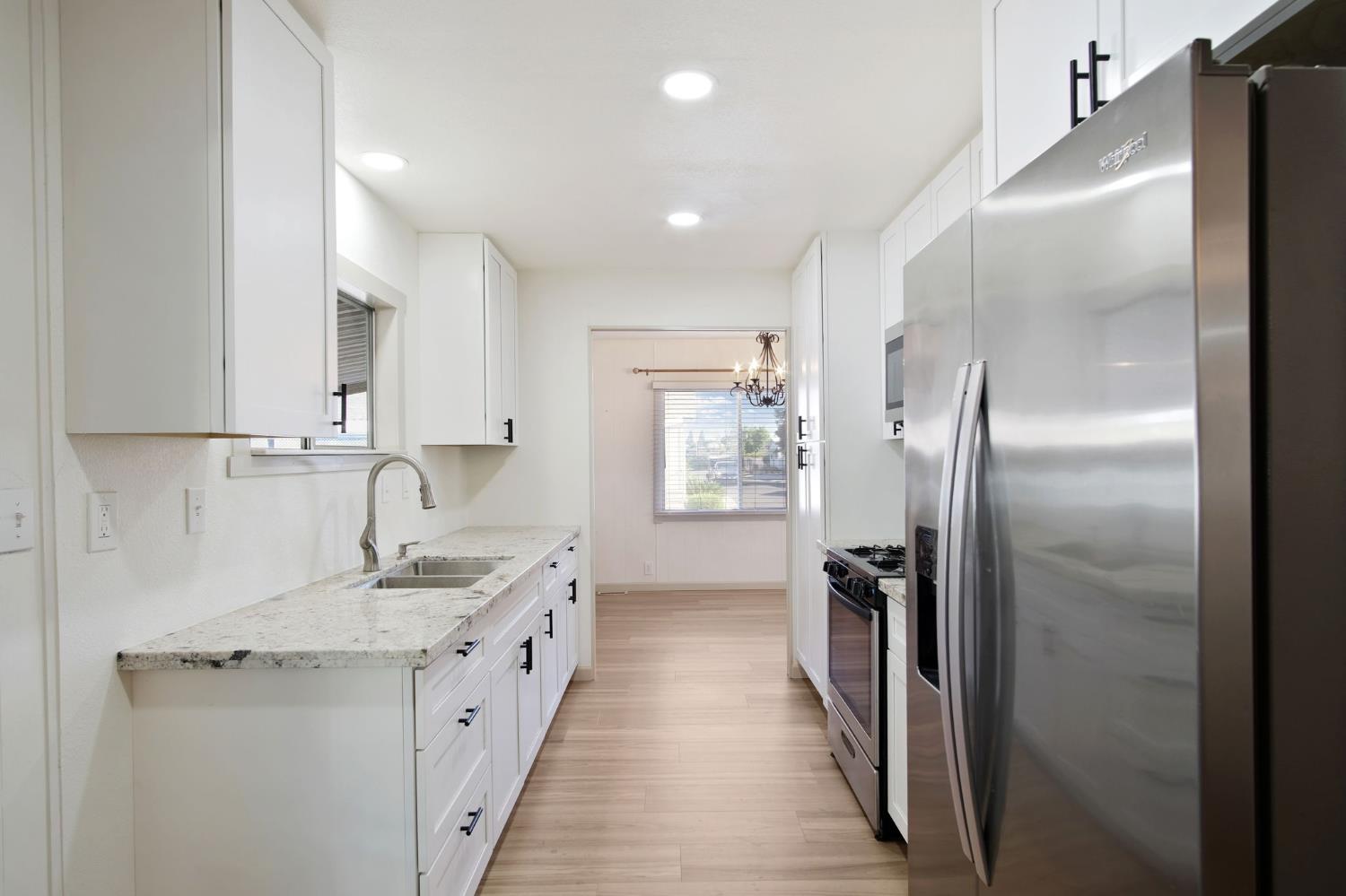 2621 Prescott Road, Unit 224 224 Modesto, CA 95350 - Photo 11 of 23 a bathroom with a double vanity sink and a mirror